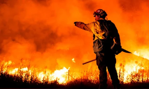 Firefighter gives direction amidst wild blaze