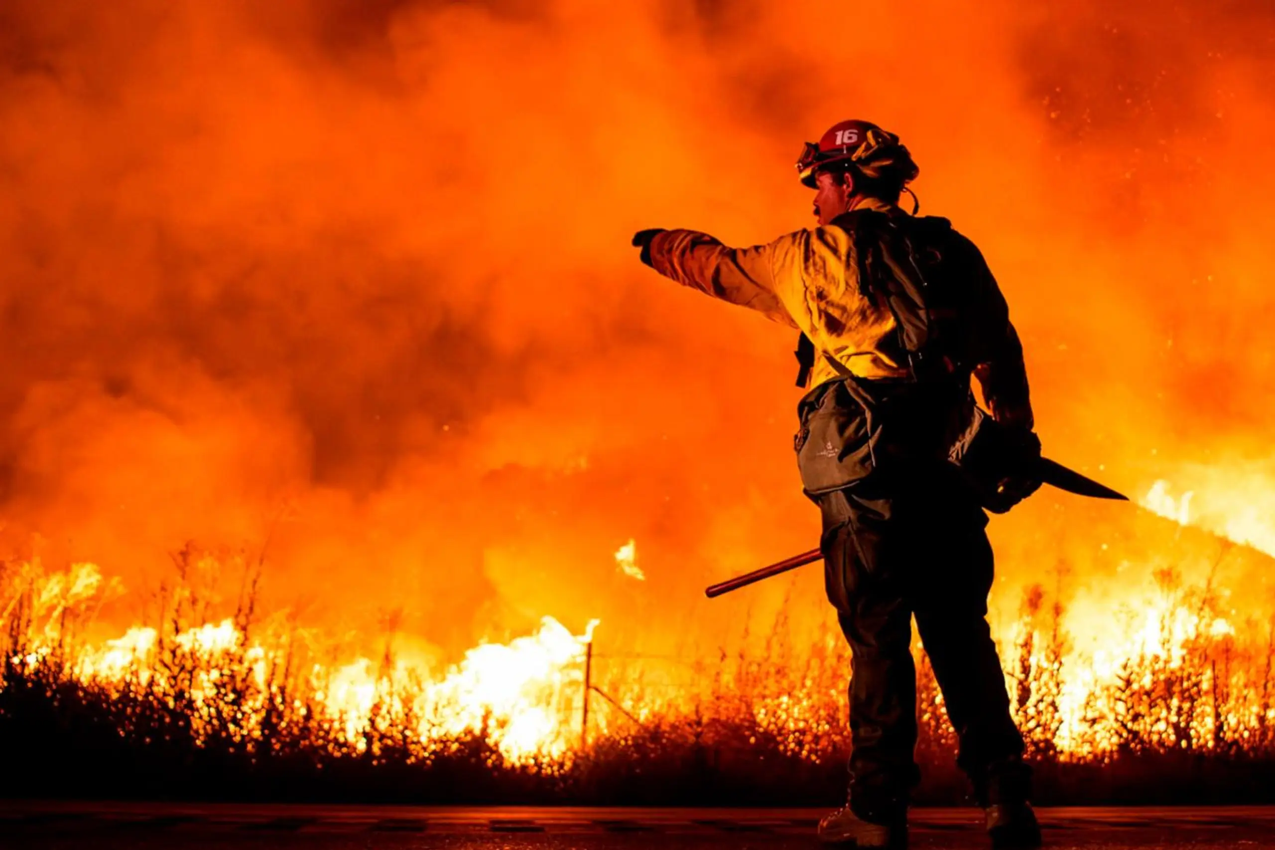 Firefighter gives direction amidst wild blaze